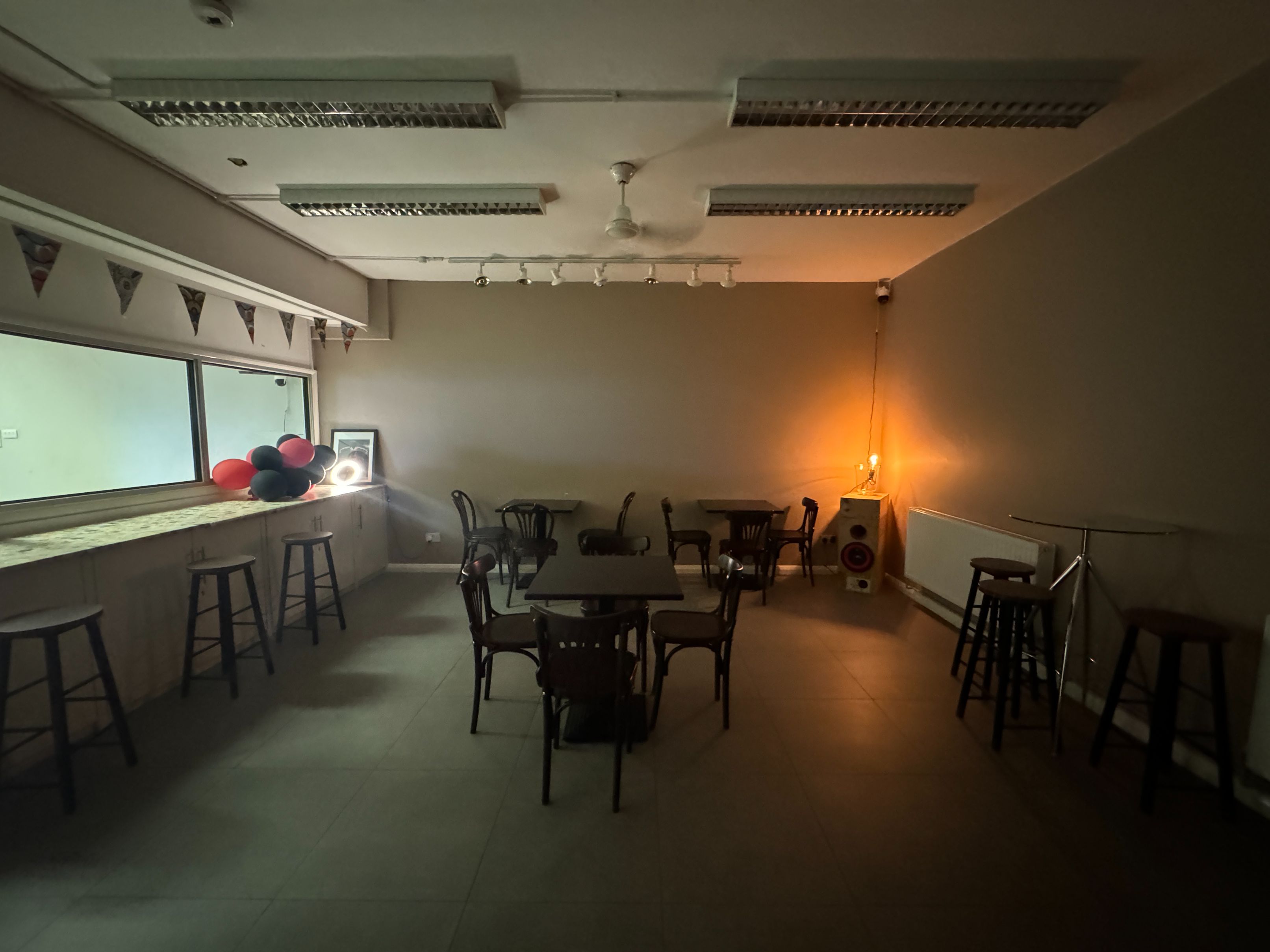 Cosy ambient view of Brixtonia Lounge with soft lighting and minimalist decor, ideal for 50-person events.