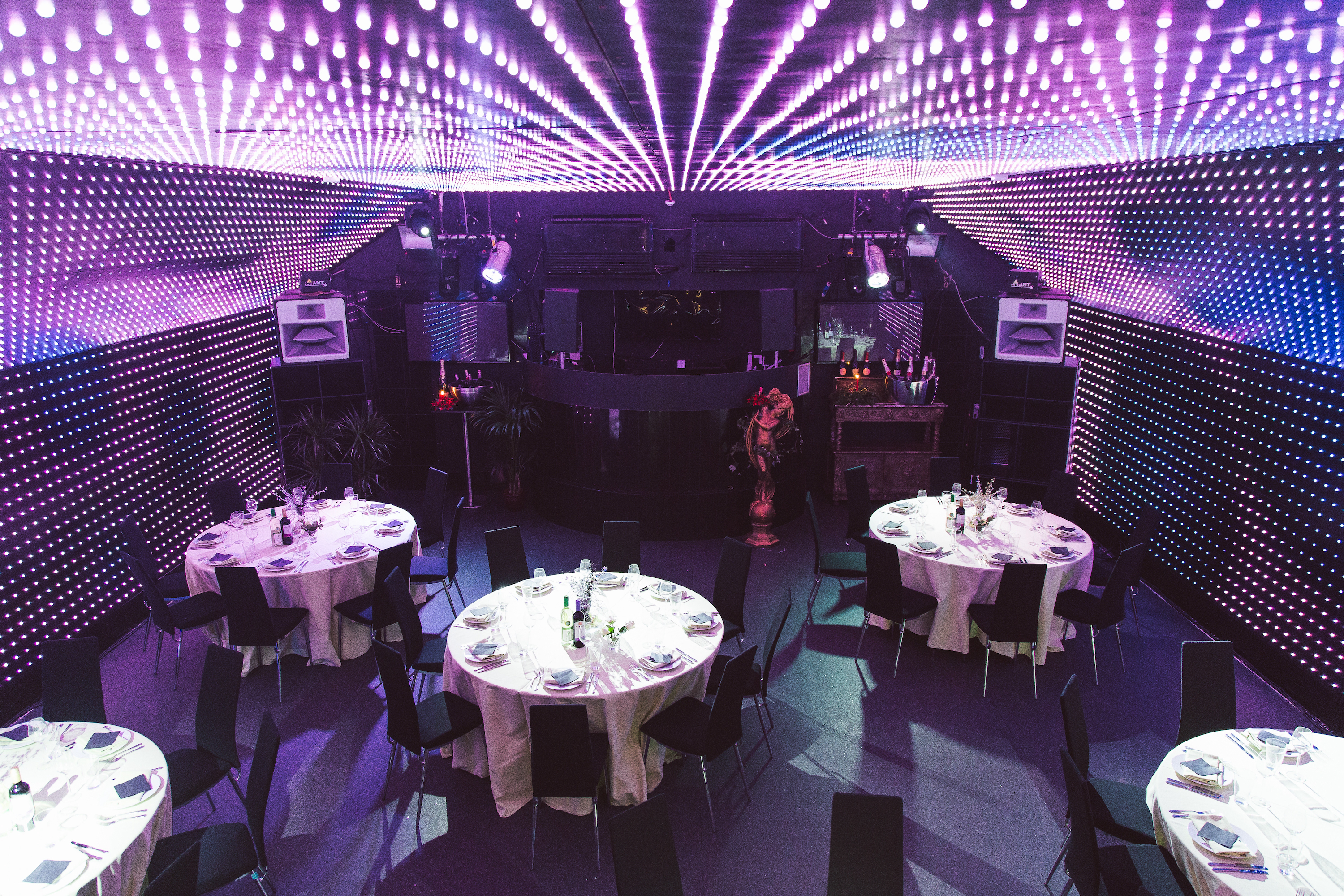 The stylish bar at Lightbox, a 150-capacity venue bookable through Conveenie, features a long, glowing onyx bar adjacent to the main LED room.