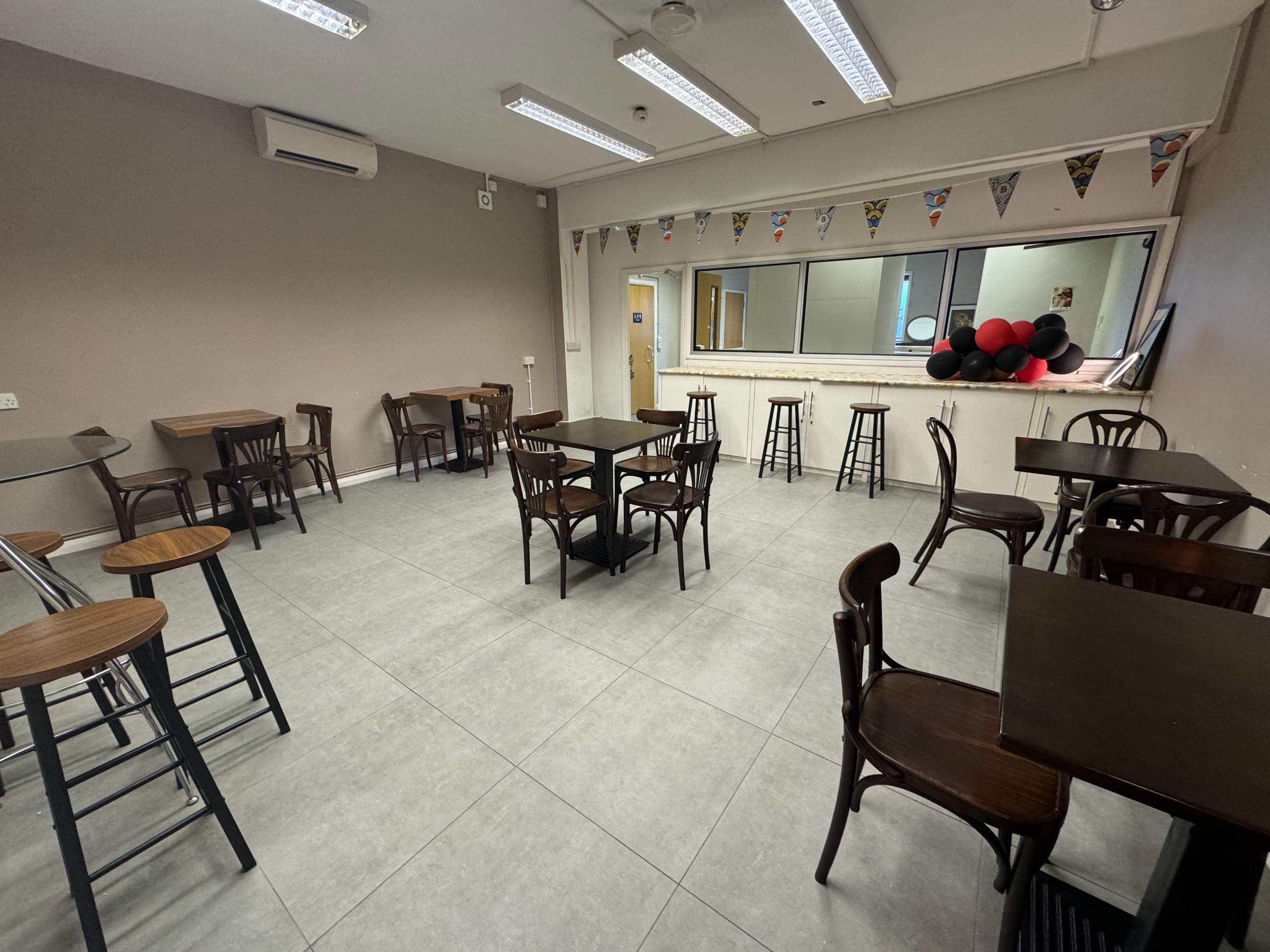 Seating setup at Brixtonia Lounge’s upstairs space, ready for parent-child groups or small classes.