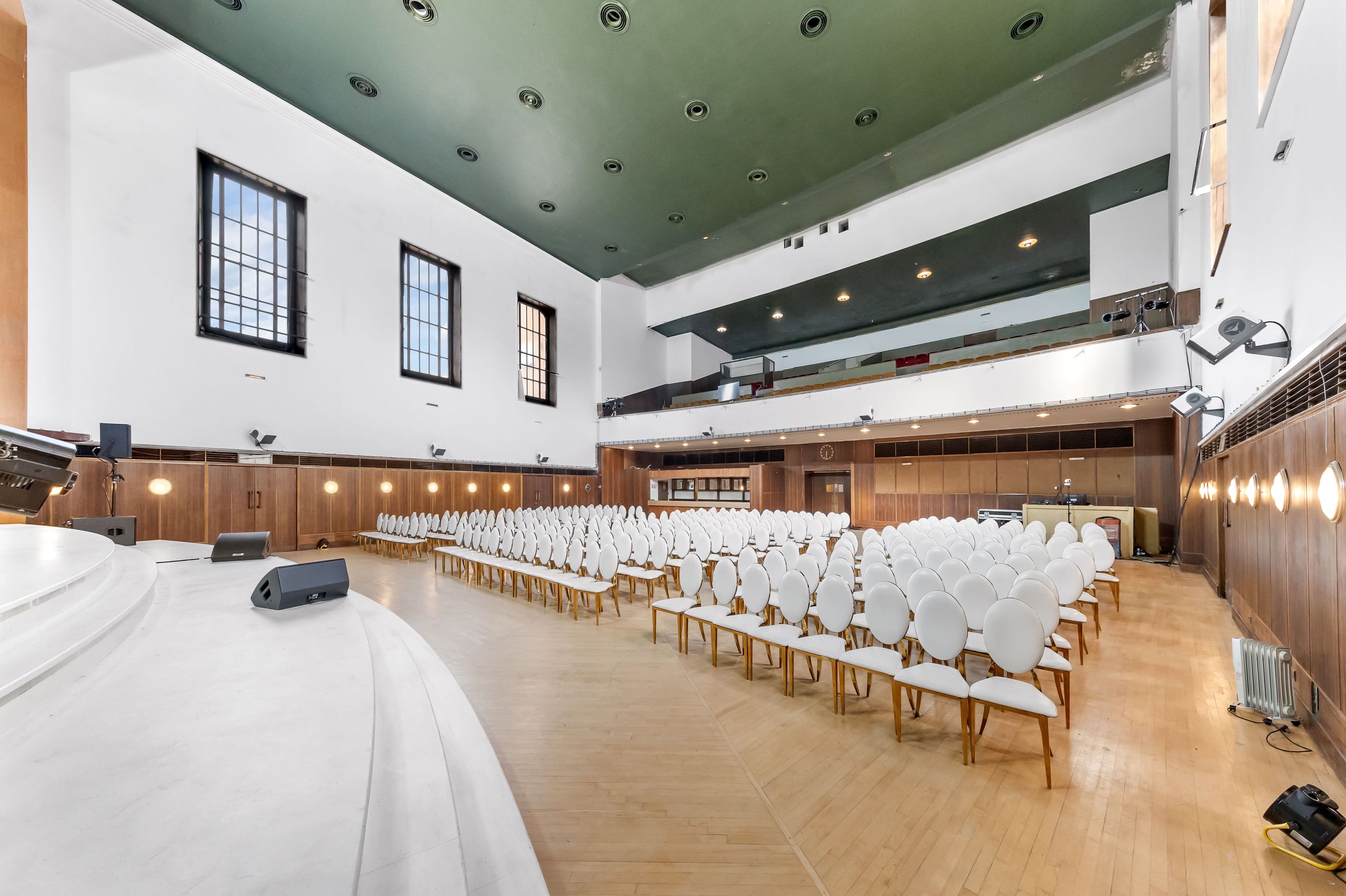 Event-ready auditorium near Greenwich Park with full seating and stage for large guest capacity ideal for community and political events