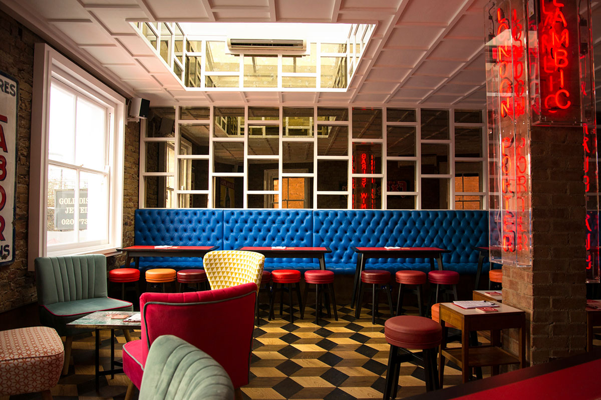 Eclectic upstairs interior with neon lighting and AV setup, perfect for events and available via Conveenie