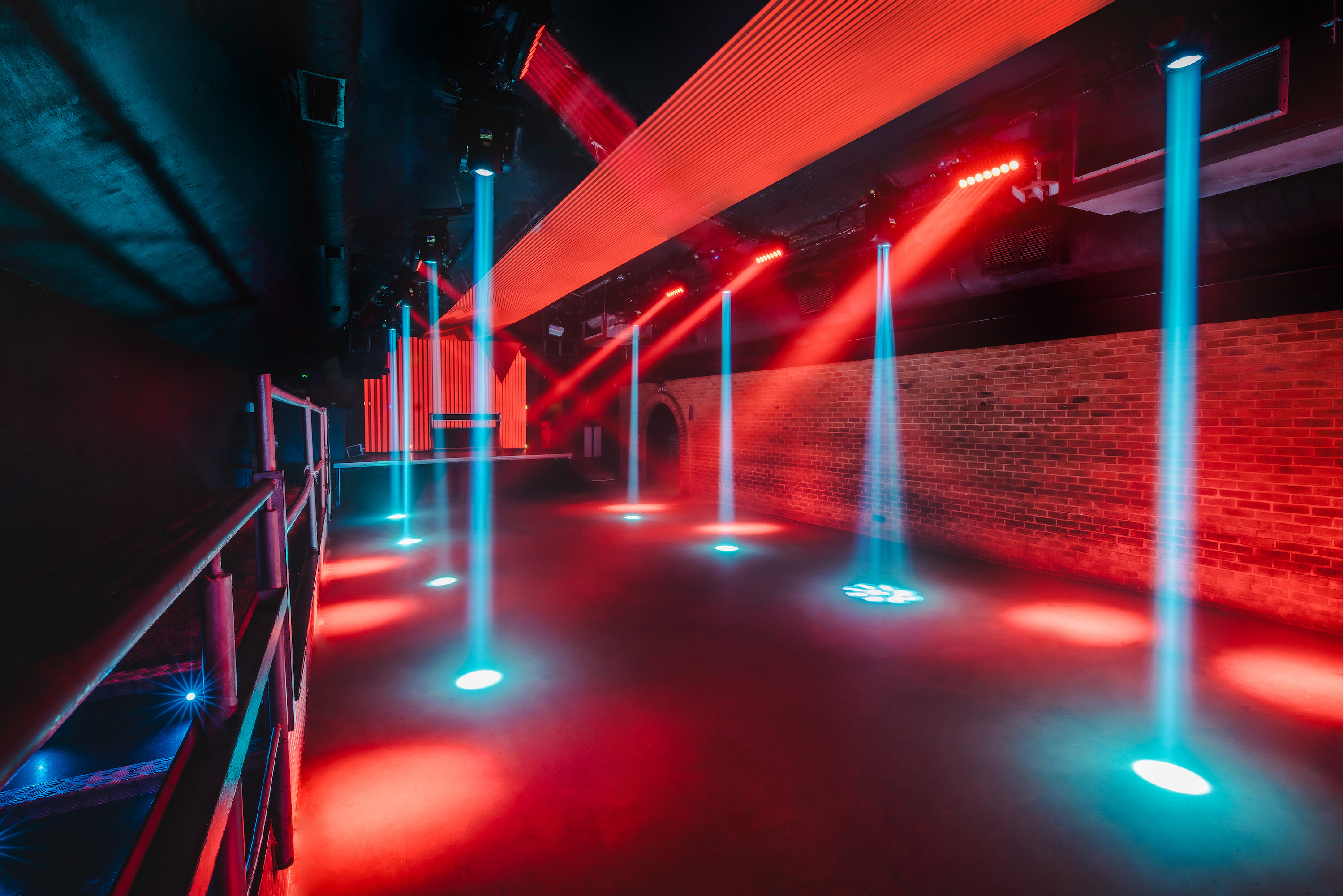 The Fire Main Room at Vauxhall Arches is set for a conference for 600, with theatre-style seating, a lectern, and a professional light grid.