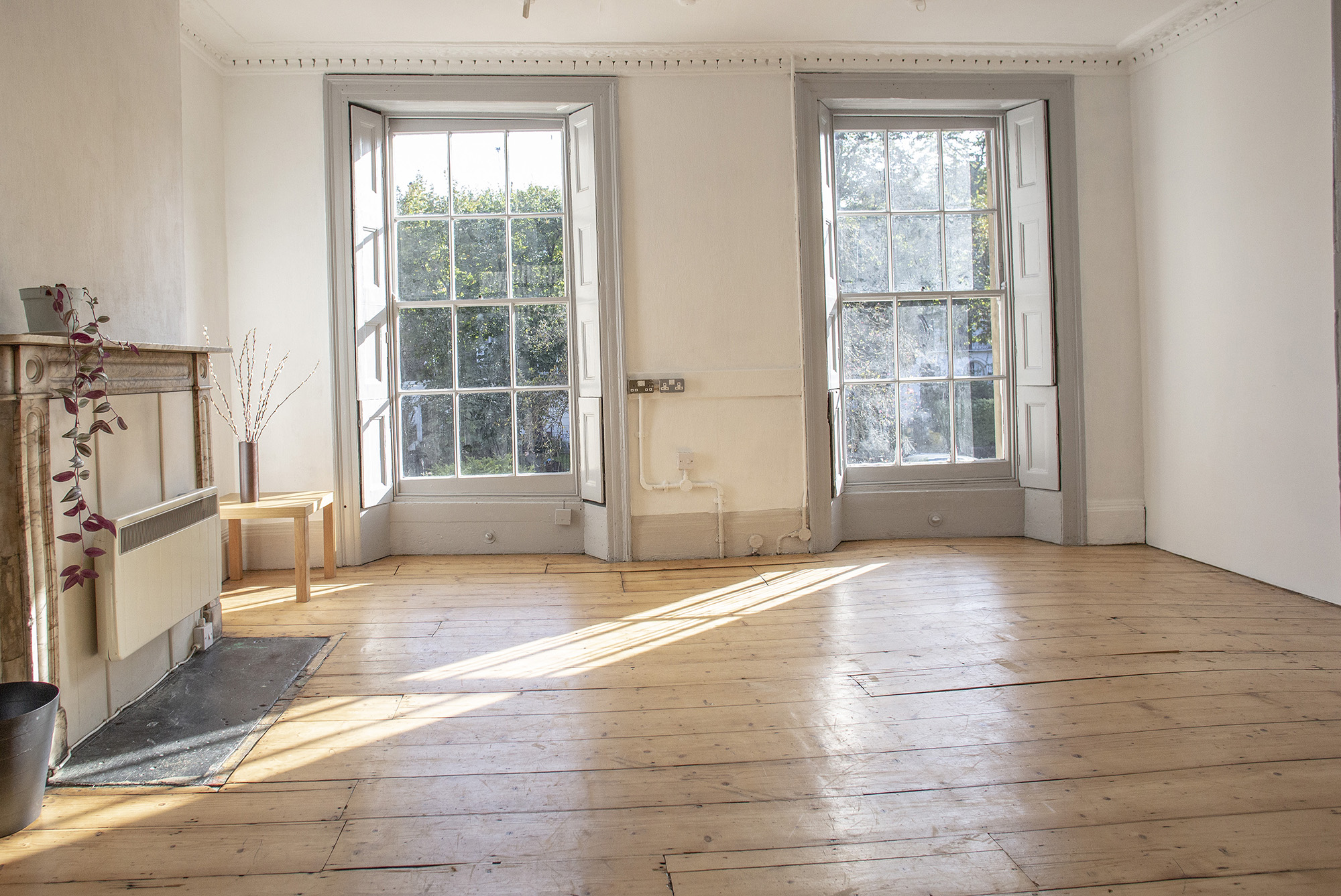 Natural light photography studio in London with wooden floors, a versatile room hire space near me for creative events.