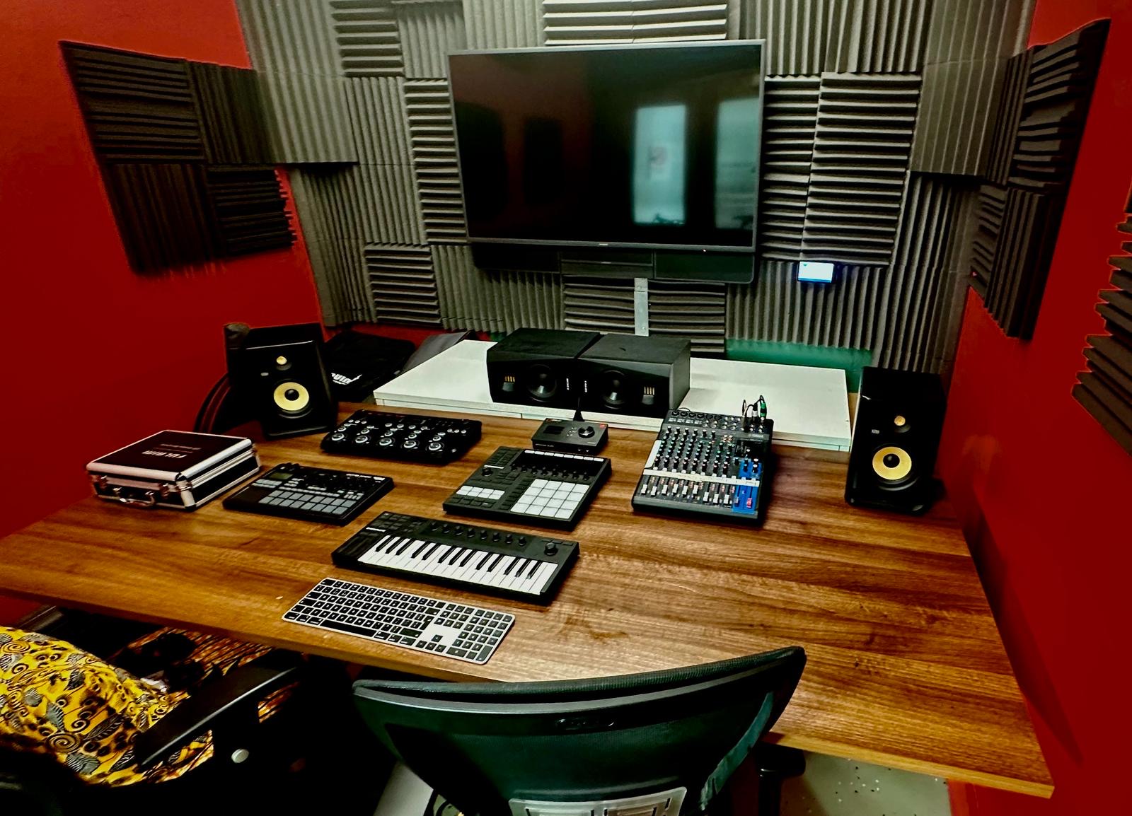 A close-up of the Recording Studio, a 35-capacity space listed on Conveenie, showing the mixing desk, speakers, synth, and soundproof foam-lined walls