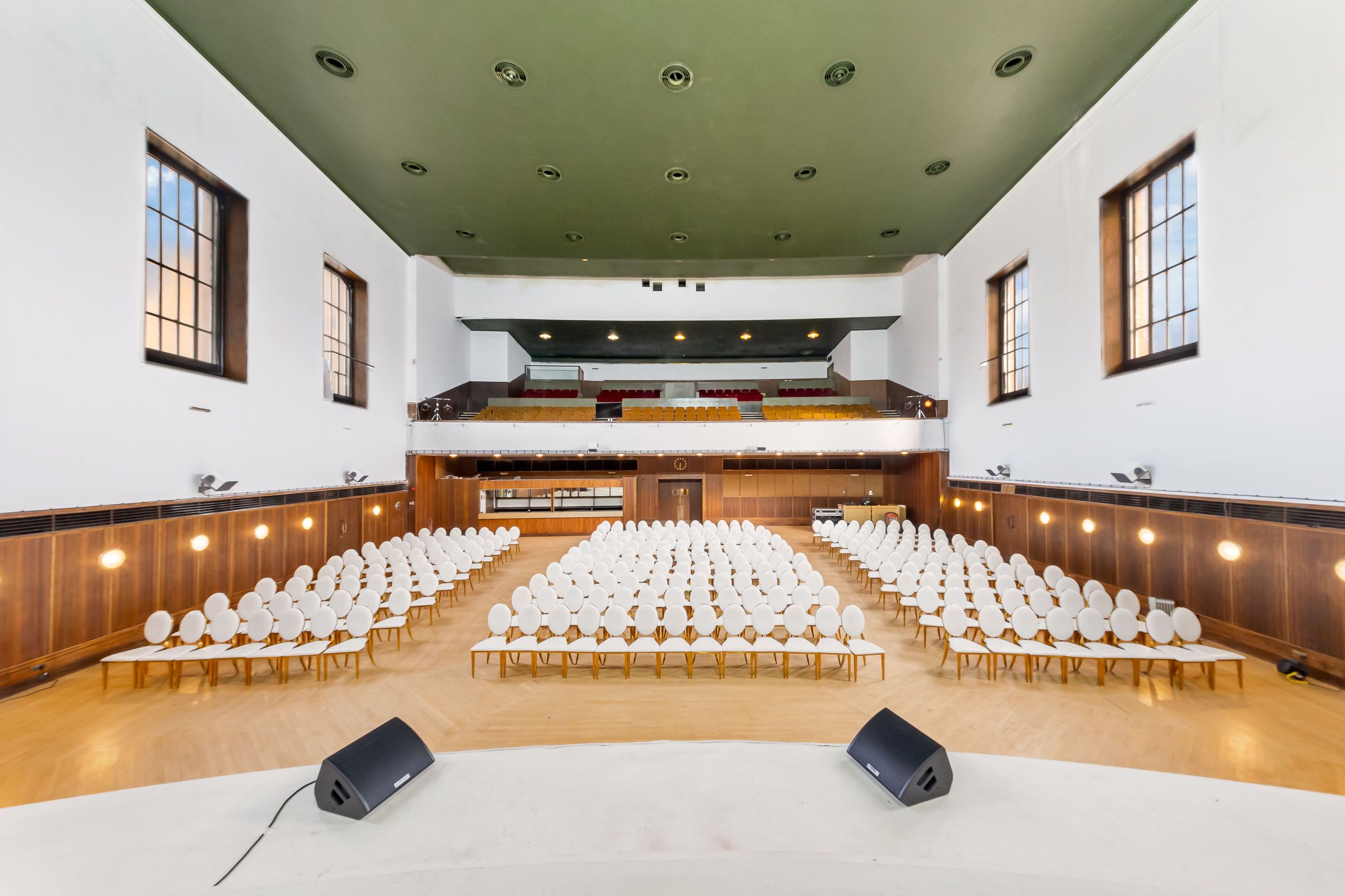 Large Borough hall with theatre-style seating and stage, suitable for lectures, weddings, or performances in heart of London